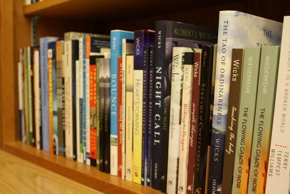 close-up of a variety of spiritual books on a bookshelf